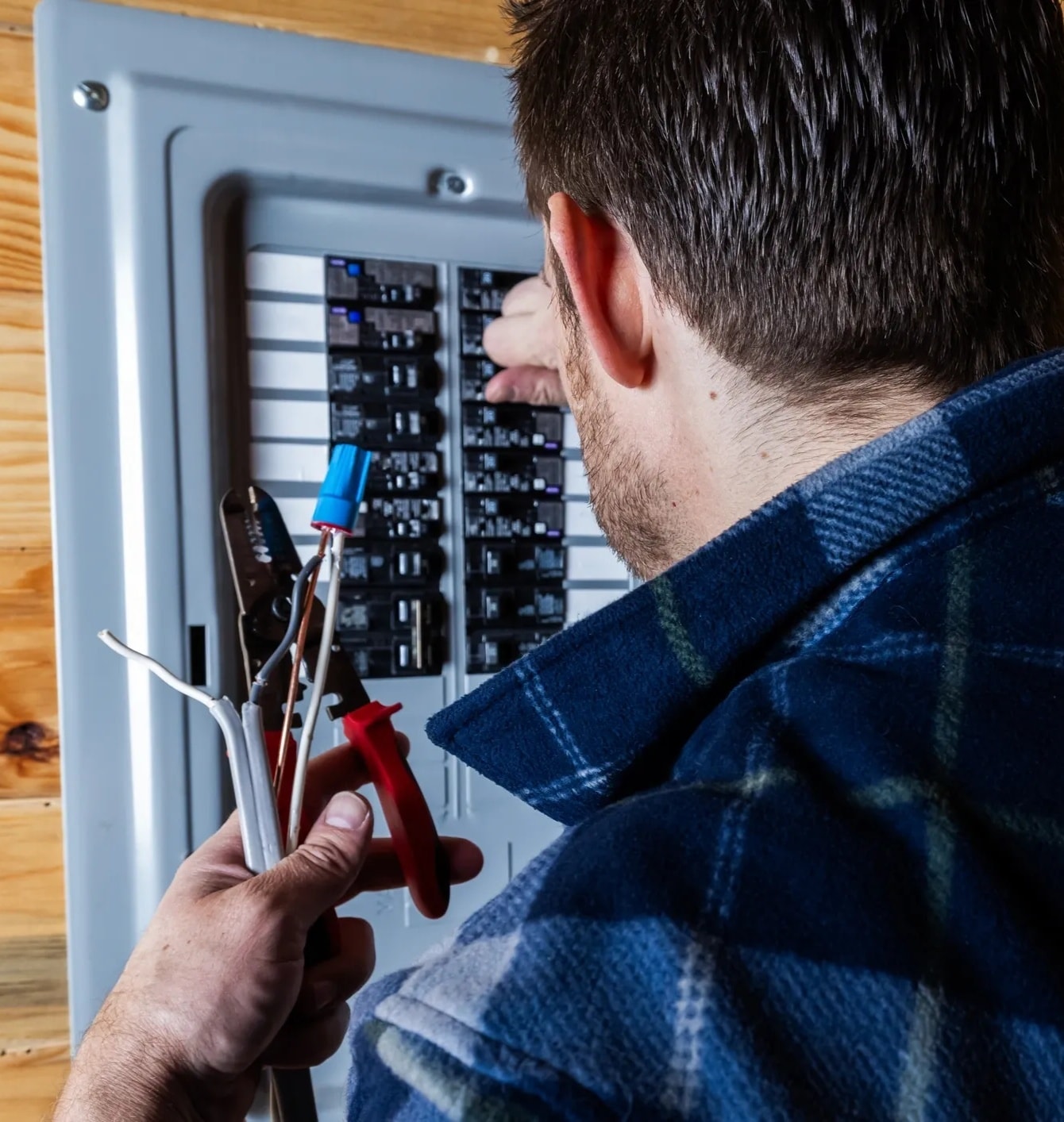 Electrician working on a residential circuit breaker panel